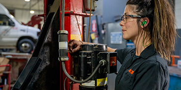 Auto mechanic student posing in the workshop